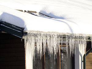 ice-sickles hanging off a roofing system 
