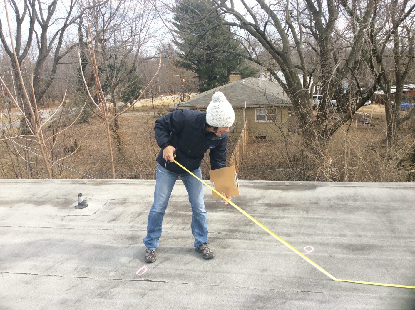 person inspecting roof top